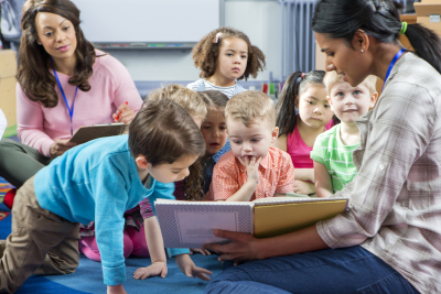 teacher giving a lesson to her students